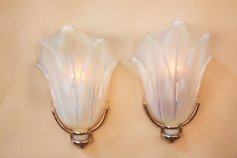 A fantastic pair of opalescent glass wall sconces with nickel on bronze hardware by Ezan. Please note that these sconces are priced per piece and sold exclusively in pairs.