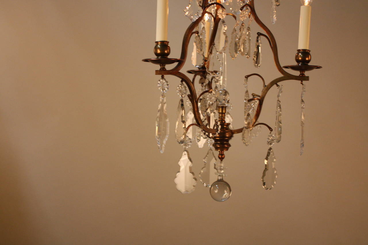 Elegant four-light French crystal and bronze chandelier.
