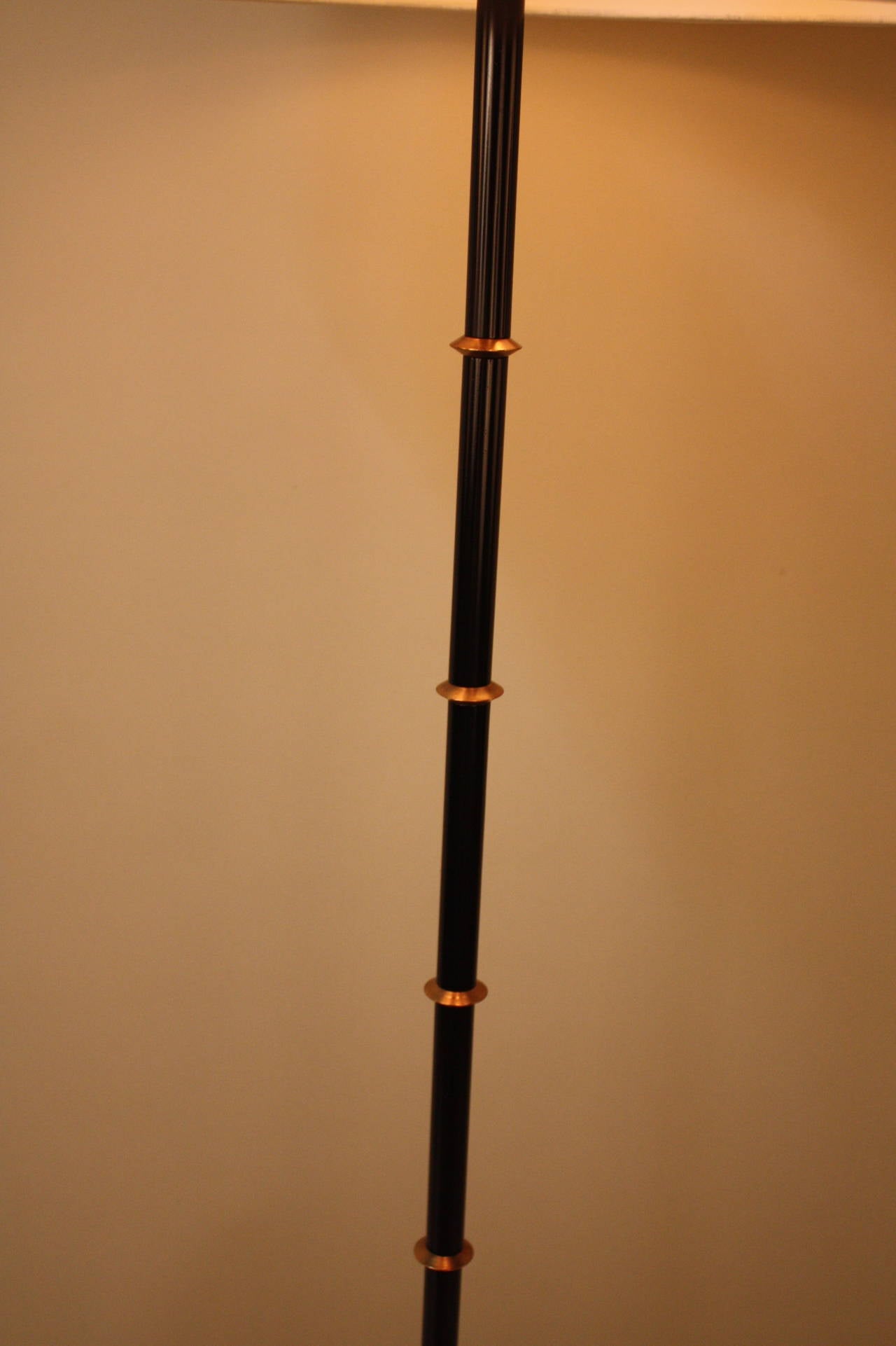 Elegant star base adjustable floor lamp in black and brass.