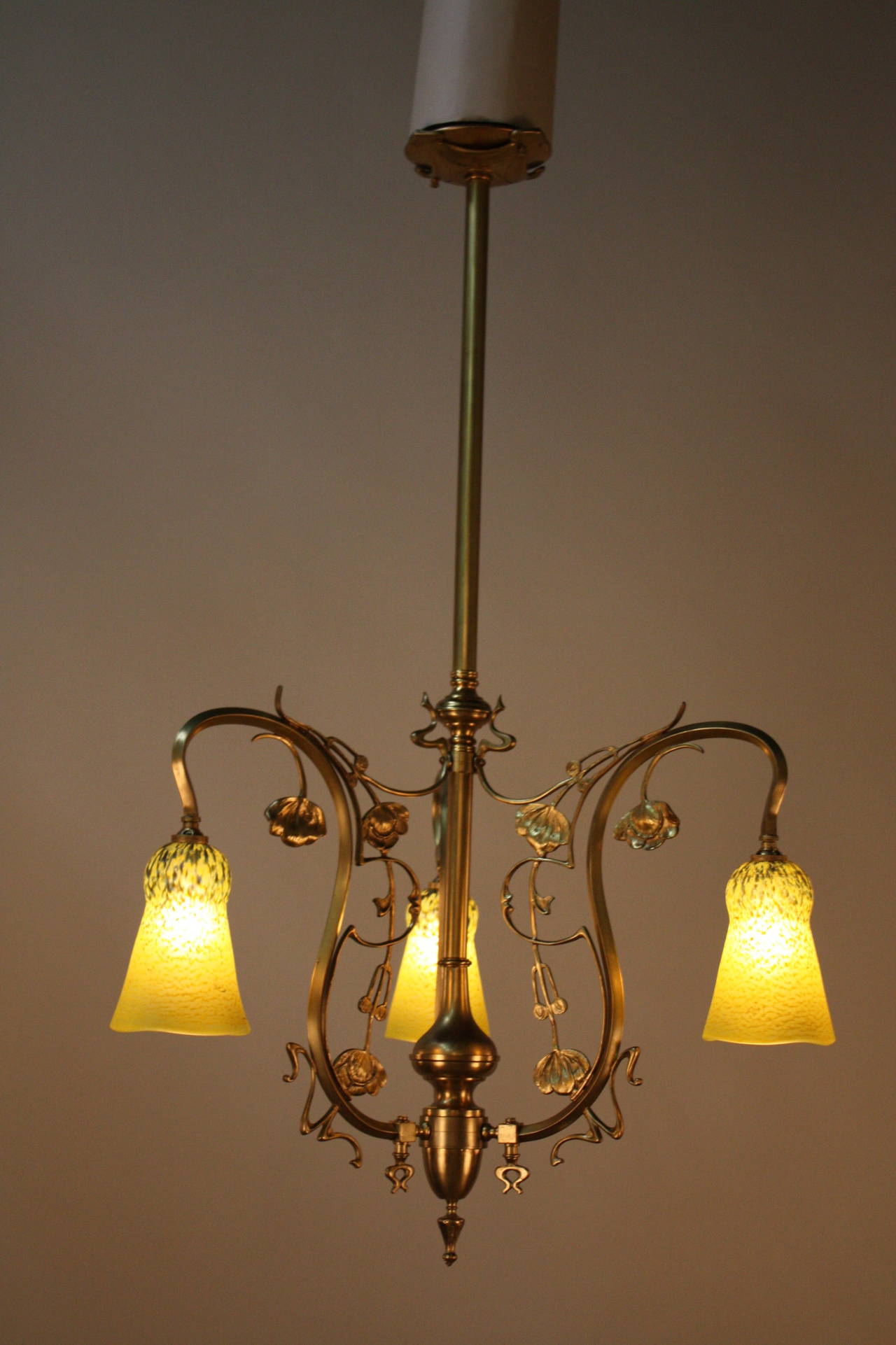Exceptional Art Nouveau electrified three-light late 19th century gas chandelier with beautiful art glass shades.
This chandelier is 23