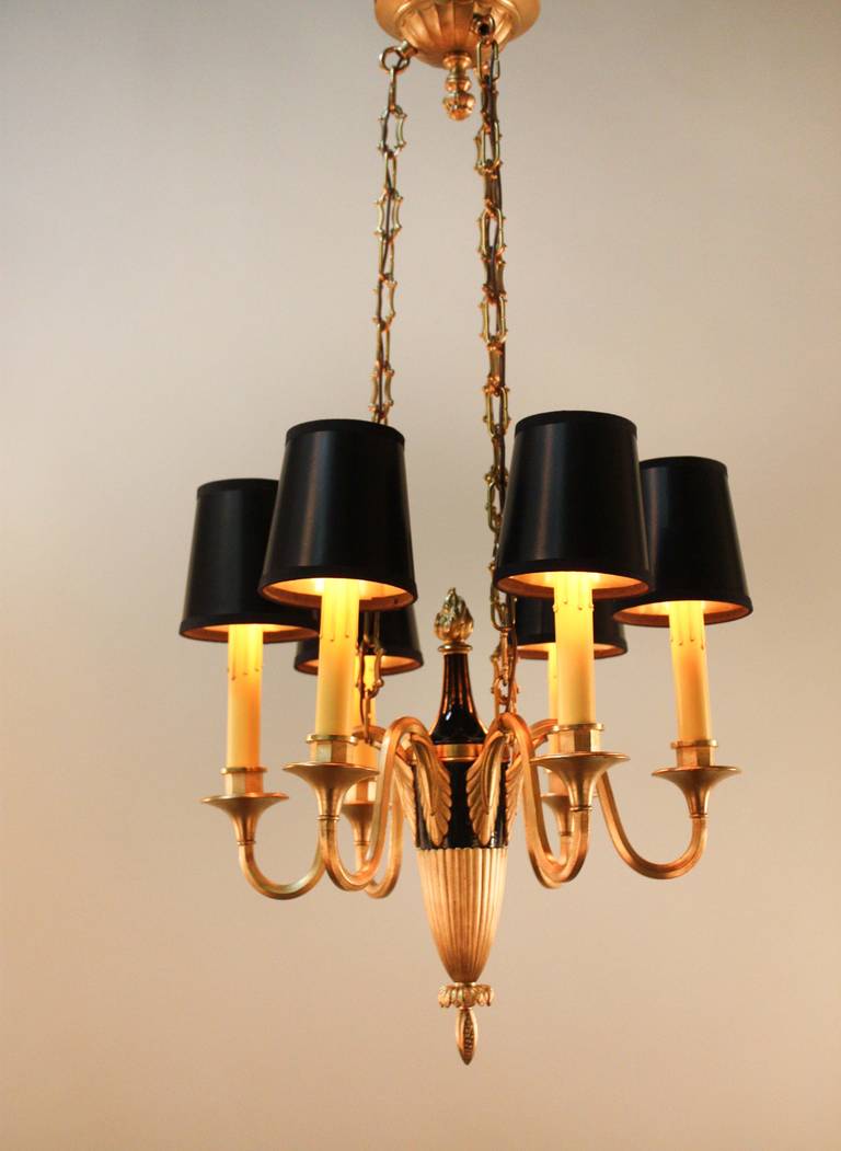 This beautiful six-light chandelier was made in the French Empire-style and features an elegant bronze and lacquer on bronze design.