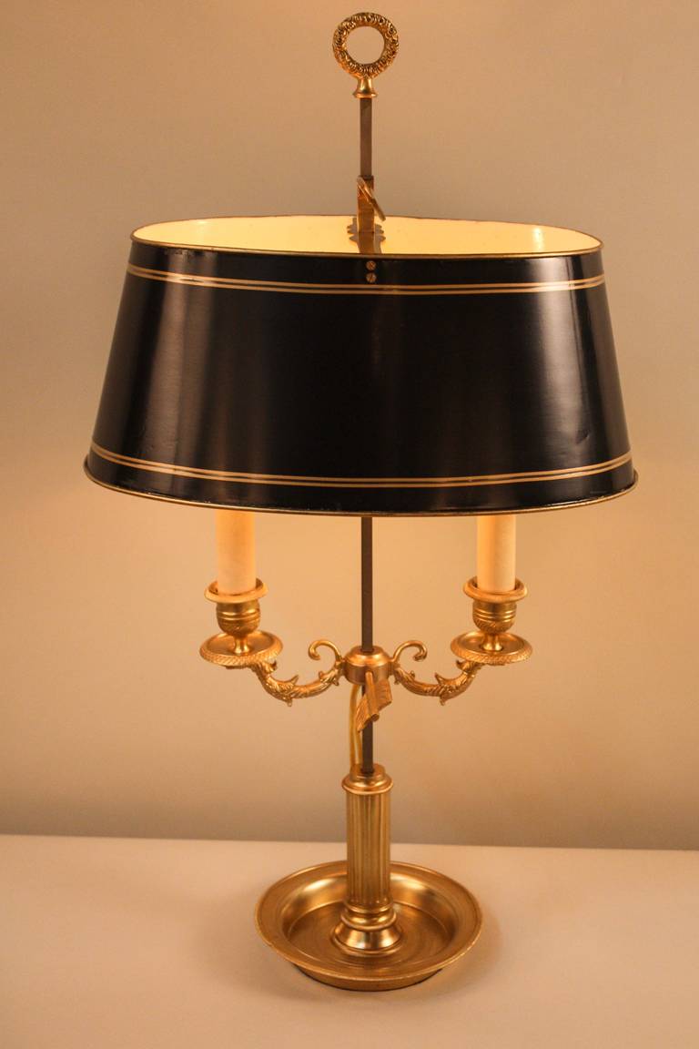 Crafted in 19th century France, this table lamp features a beautiful bronze candelabra base, originally used for traditional candles. The lamp has been professionally electrified and restored and has two lights. The height of the shade and the