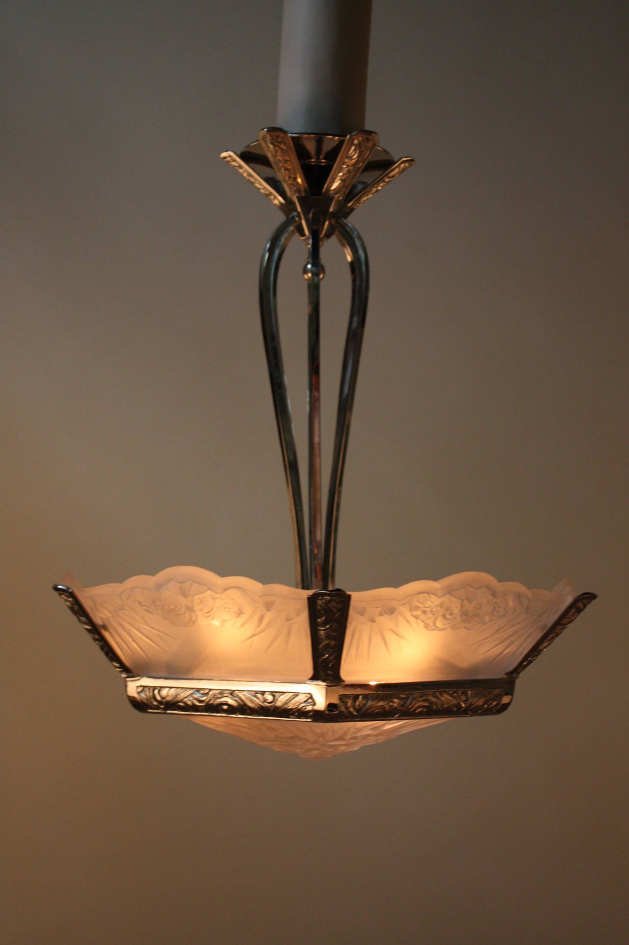 Wonderful nine light Art Deco chandelier,this chandelier is made of polished nickel on bronze with Frost glass with high light polish on the raised part of the glass.