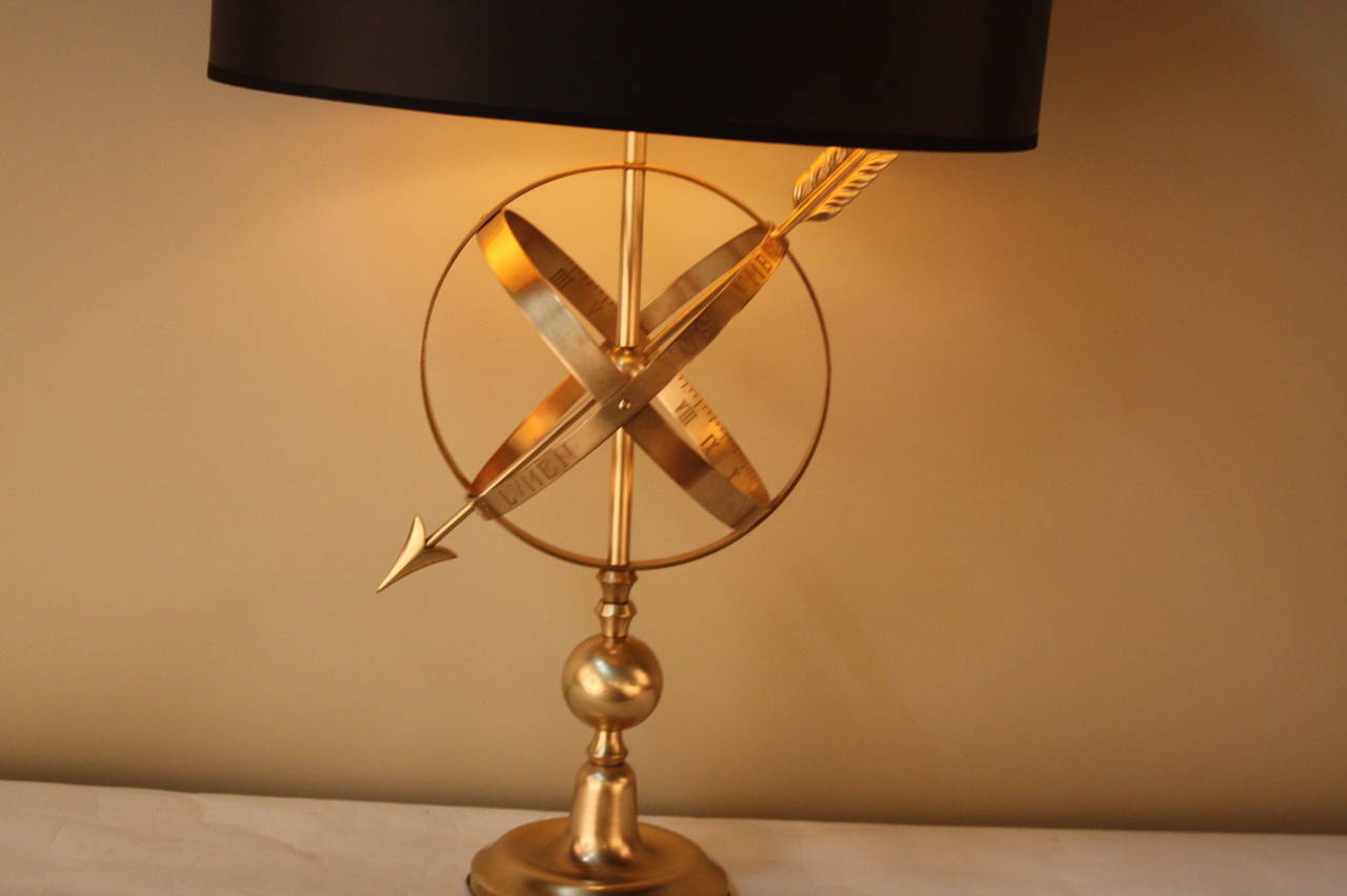 Elegant French bronze table lamp with Hillary sphere.
This bronze consisting of a spherical framework of rings, centered on Earth.
Fitted with oval black lampshade.