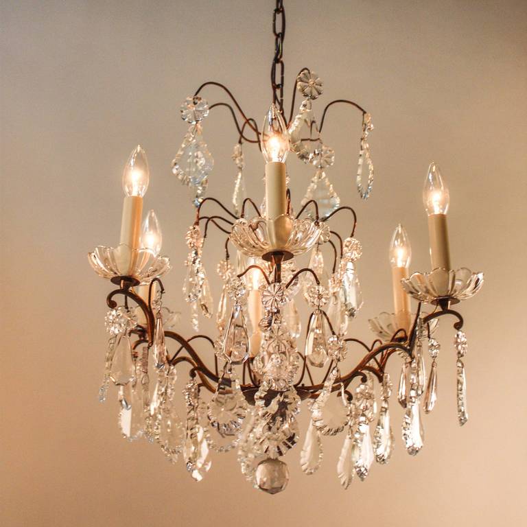 Crafted in France during the 1930s, this gorgeous six-arm crystal and bronze chandelier will add an elegant ambience to any space. 

This chandelier measures 21