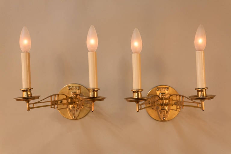 Pair of Art Nouveau bronze wall sconces. This adjustable wall sconces originally hold candle and were design to go on each side if piano which have been electrified. Due to adjustability of the arms measurement is not precise.