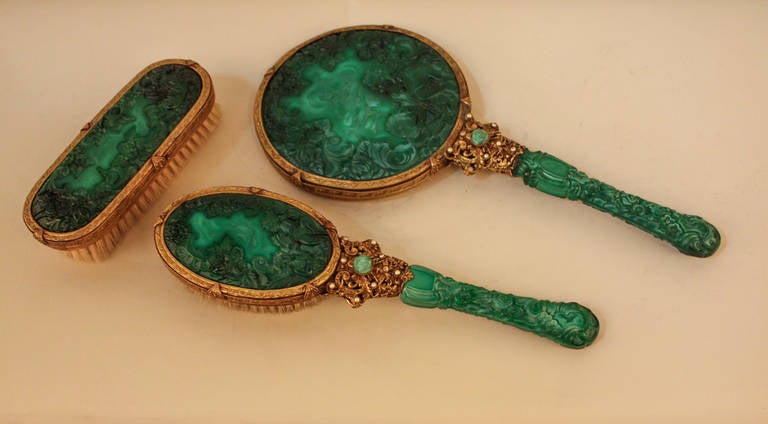Fantastic three-piece Czechoslovakian dresser set from 1930s. The dark green glass with deep cut cherubs playing music framed in bronze is so beautifully done, it resembles real malachite which shows true art in Czech glass.