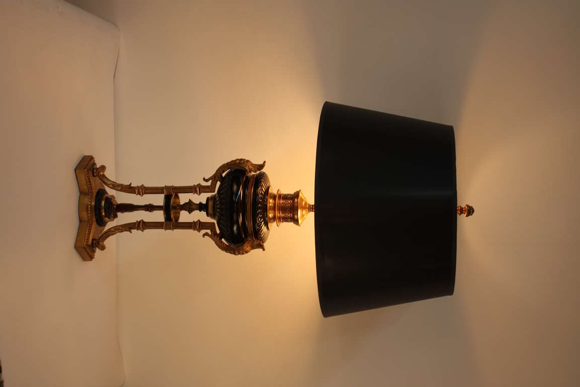 A beautiful 19th century piece. Made in France, this stunning Second Empire table lamp was originally an oil burning light; it has been custom converted and electrified. Classic bronze and black lacquer adorn this wonderful table lamp. A truly great