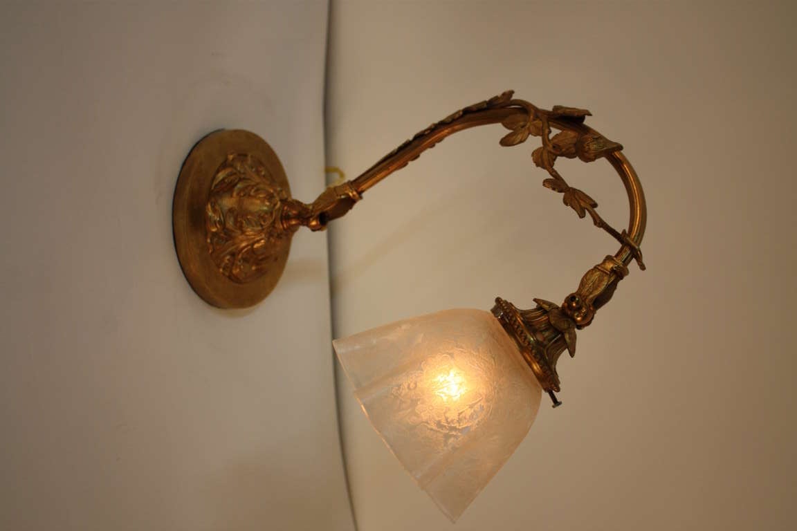 A beautiful French lamp. Made of elegant bronze, this lamp features a fantastic etched glass shade. An adjustable light, this lamp works perfectly as a table or desk lamp.