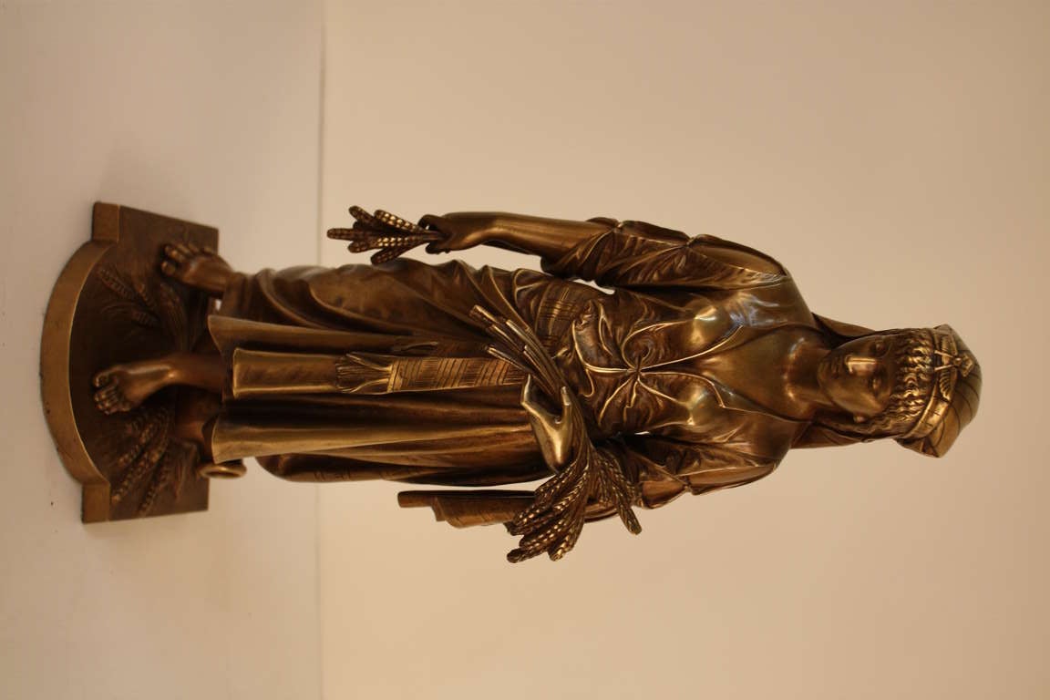 A beautiful bronze sculpture by renowned French artist Eutrope Bouret (1833-1906), this piece depicts a woman gathering wheat. Stunning detail work throughout the bronze makes it truly fantastic.