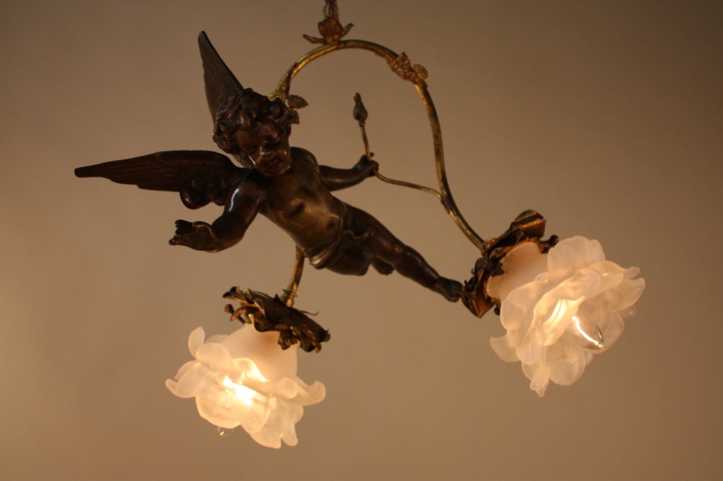 FRENCH CIRCLE 1930 CHANDELIER , A BRONZE CHERUB HOLDING A ROSE BUD. THIS LIGHT HAS TWO LIGHTS WITH GLASS ROSES.
