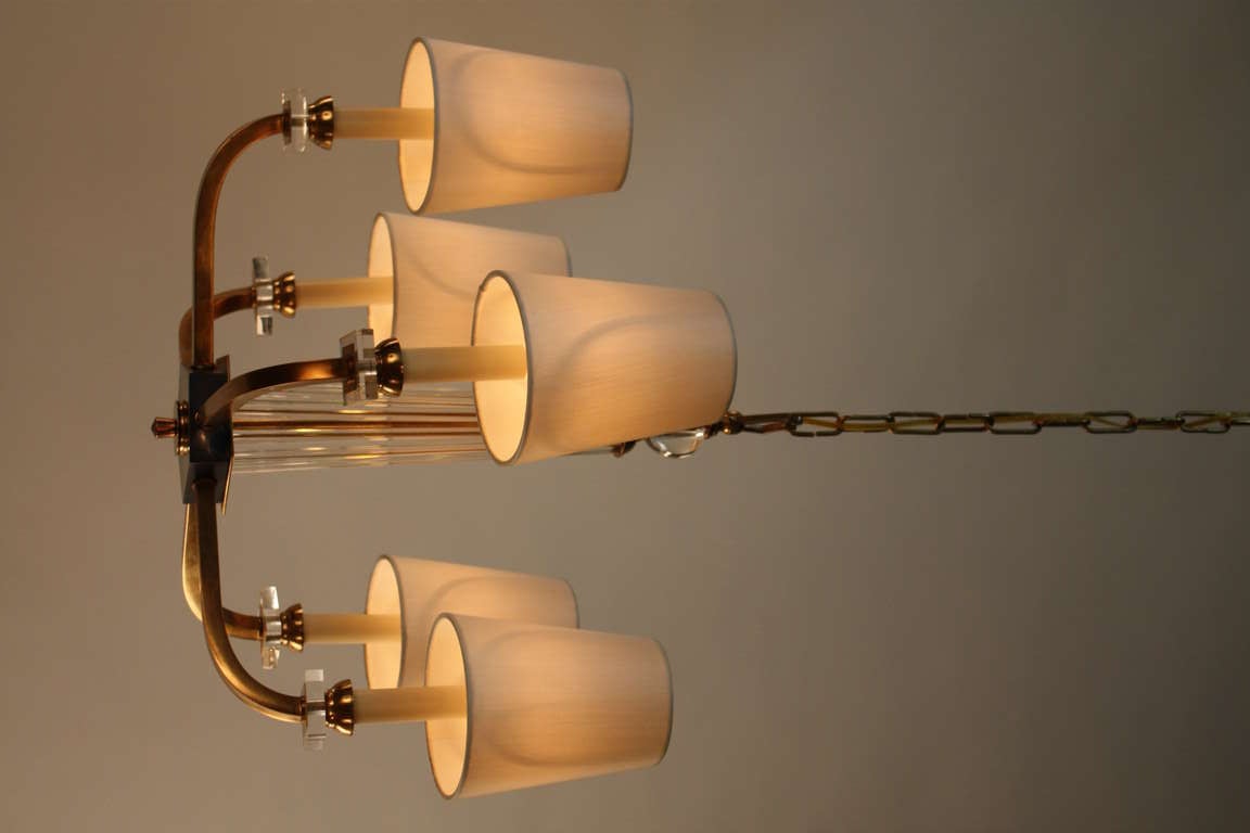 Simple but elegant five arm bronze and crystal chandelier by modernist designer Jacques Adnet