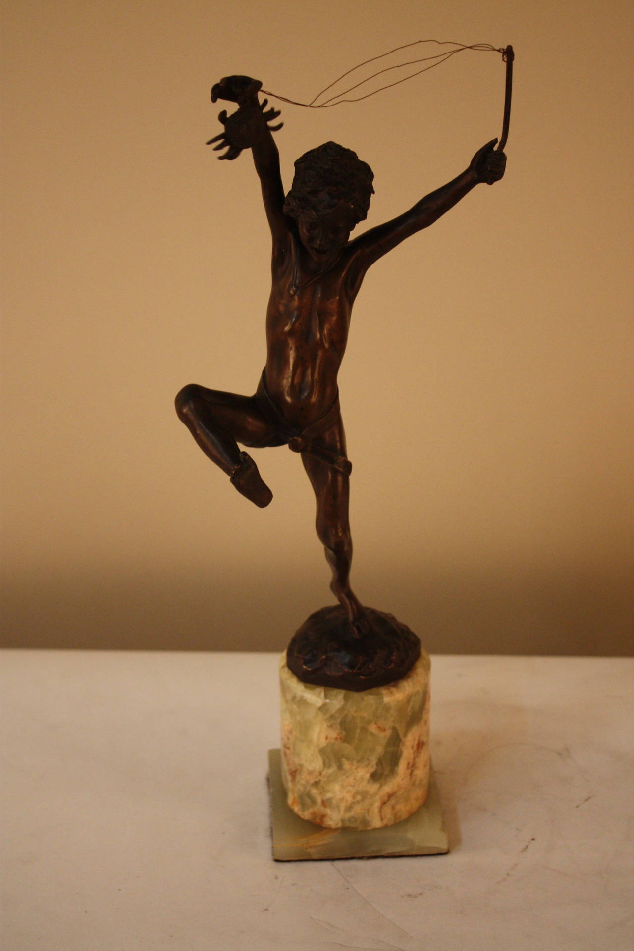Beautiful brown patina bronze sculpture depicting a boy catching a crab rather than a fish. Sculpture expresses a fantastic face and body expression.