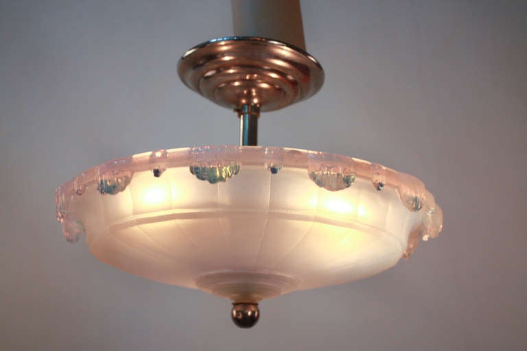 A beautiful piece by Ezan, this French flush mount lighting fixture is made of stunning chrome. Featuring frosted glass and three lights, this piece is both classic and modern.