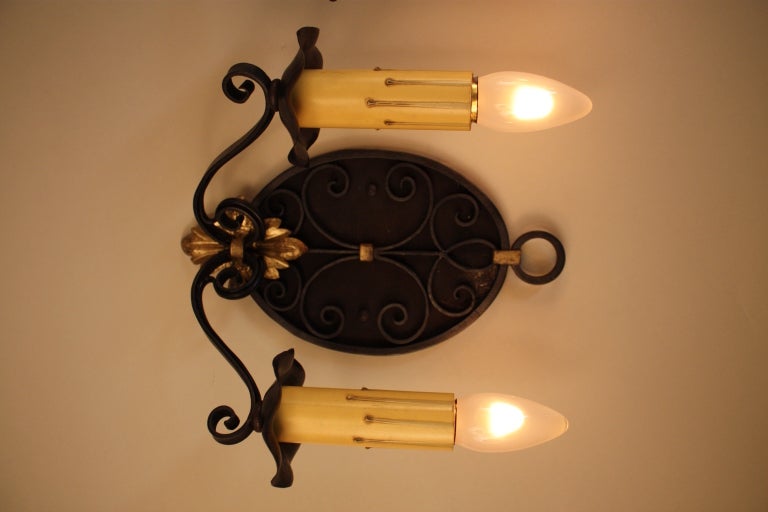 Two pair of double arm, two color tone French iron wall sconces.

Price is for one pair.