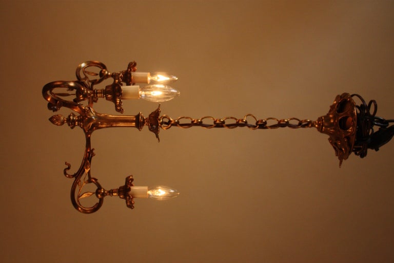 WONDERFUL ART NOUVEAU THREE ARM BRONZE CHANDELIER WITH VERY DECORATIVE LEAVES AND SCROLL WORK.