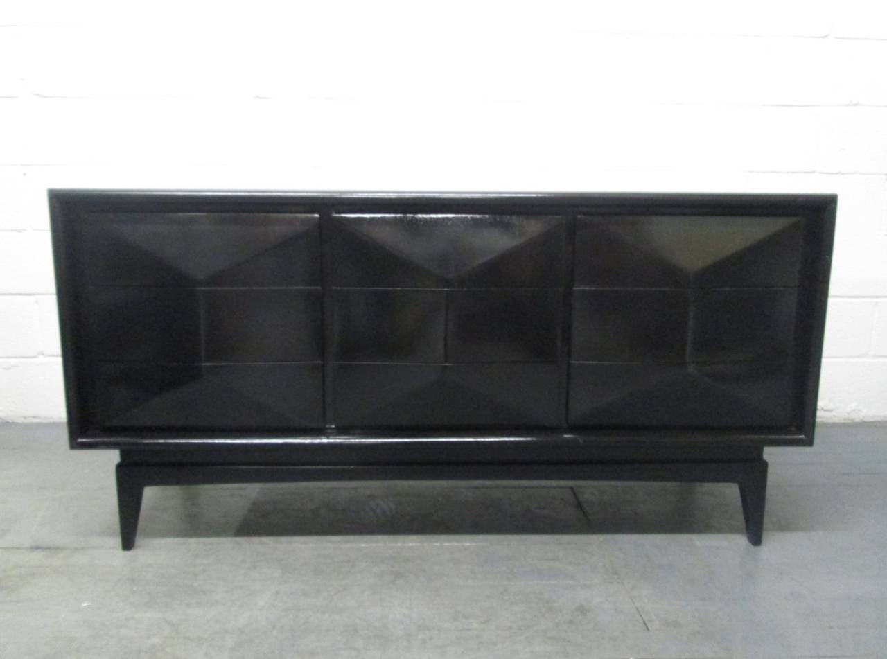 Remarkable diamond front dresser. Can also be used as a credenza. Has a total of nine drawers with a three dimensional diamond front pattern to the front of the drawers. Dresser has a black lacquered finish.