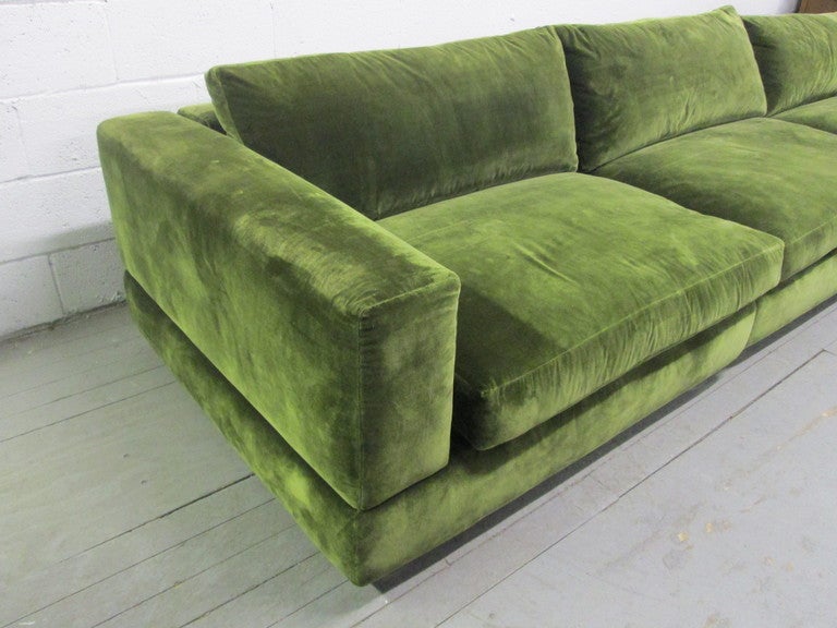 Three sectional sofa by Minotti.  Sofa has a green upholstered fabric and very modern chrome feet.