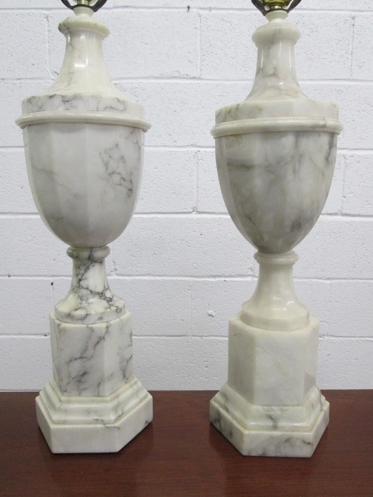 Sunning pair of Italian marble urn lamps with nice grains. One is slightly taller. Taller measures: 33.5