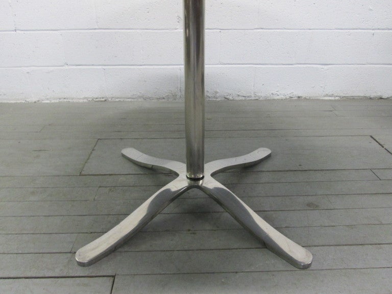 Nicos Zographos table with a black granite top and chrome base. Great looking item for a Mid-Century Modern interior.