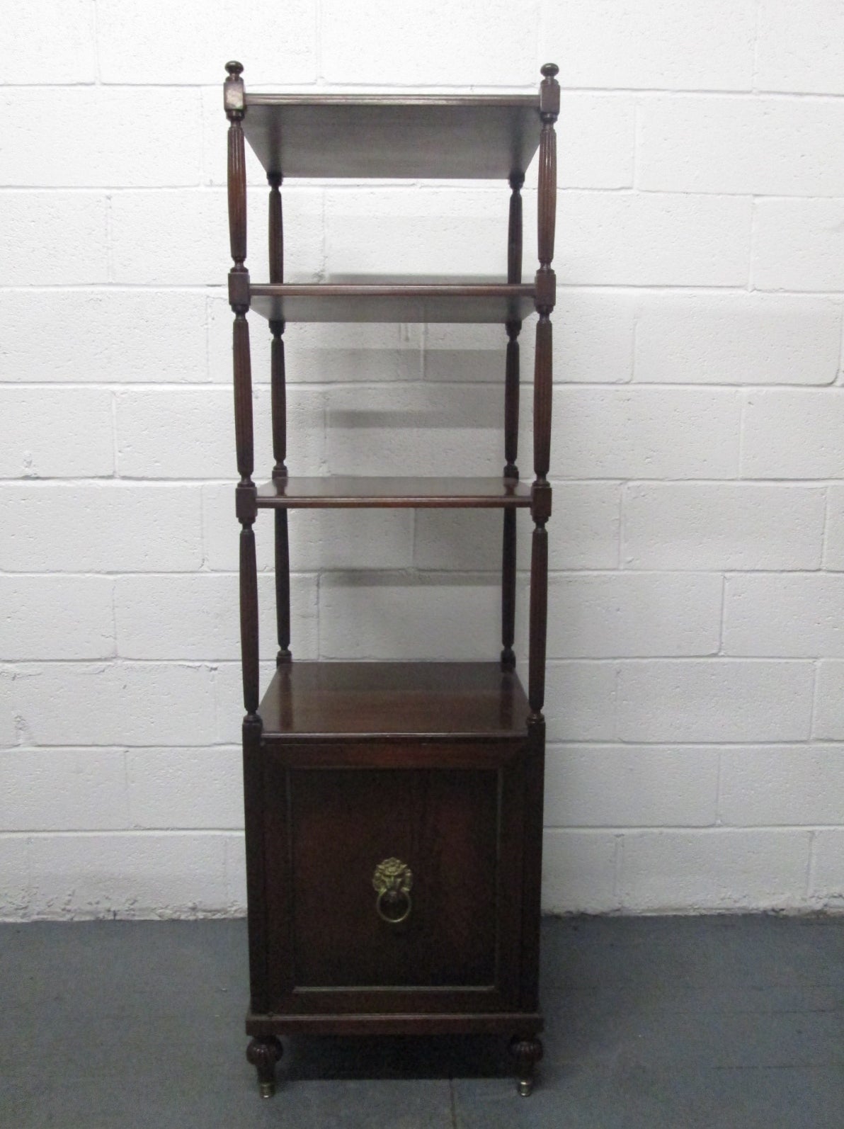 Pair of Regency style mahogany etageres. Has a cabinet underneath for storage.