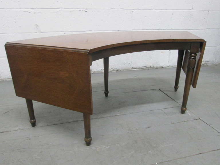 Rosewood Drop Leaf Curved Coffee Table.
With leaves down, measures:  18.5"H x 48"W x 19.5"D.  The width with the leaves up is 64"W. Recommend refinishing. 