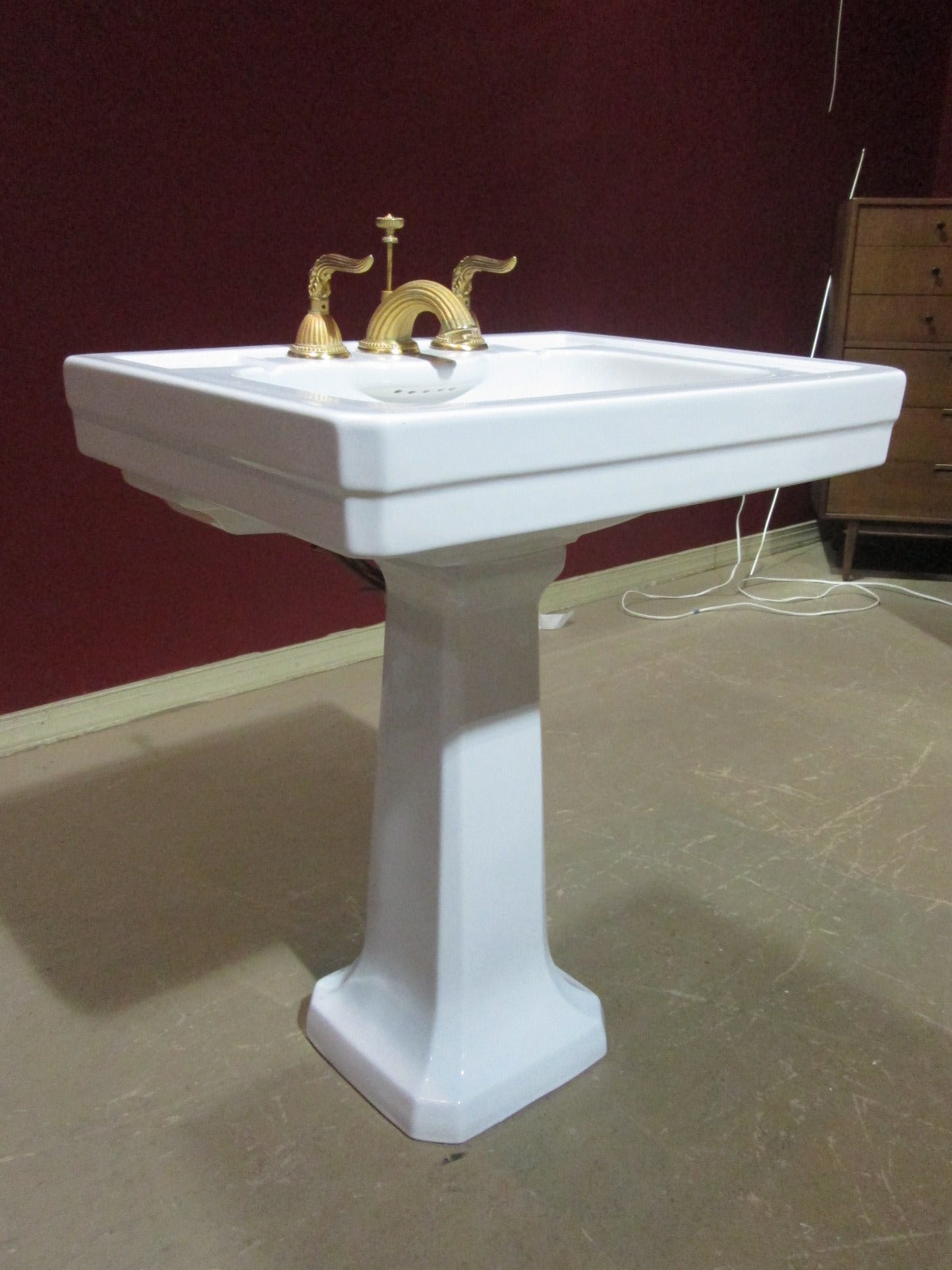 Pedestal porcelain sink with gold plated decorative fixtures. Sink comes on two parts. Sink stamped made in Italy.