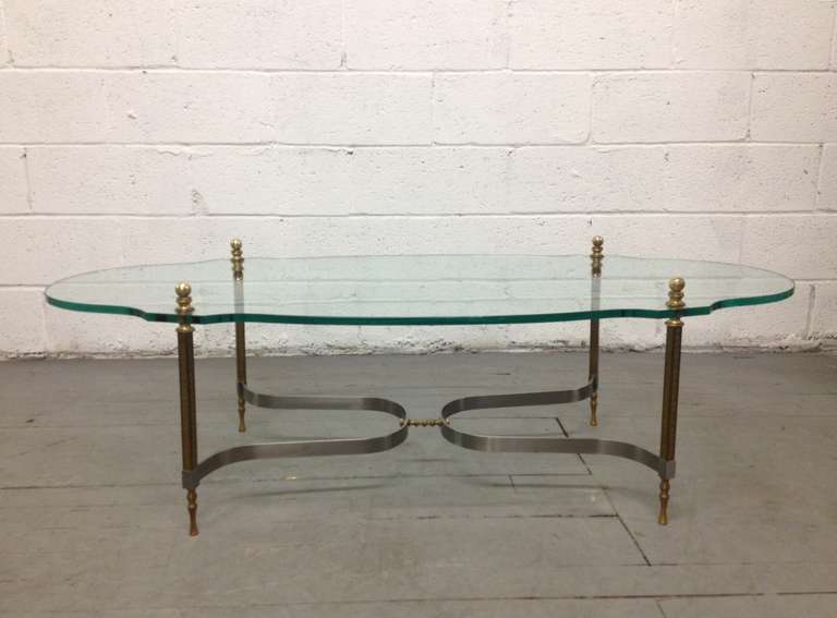 Table has solid brass legs and fittings by Labarge.  Glass has a wonderful shape having round brass finials. Some scratches to the glass.  Base has curvy stretcher. 
Height of the table is 18