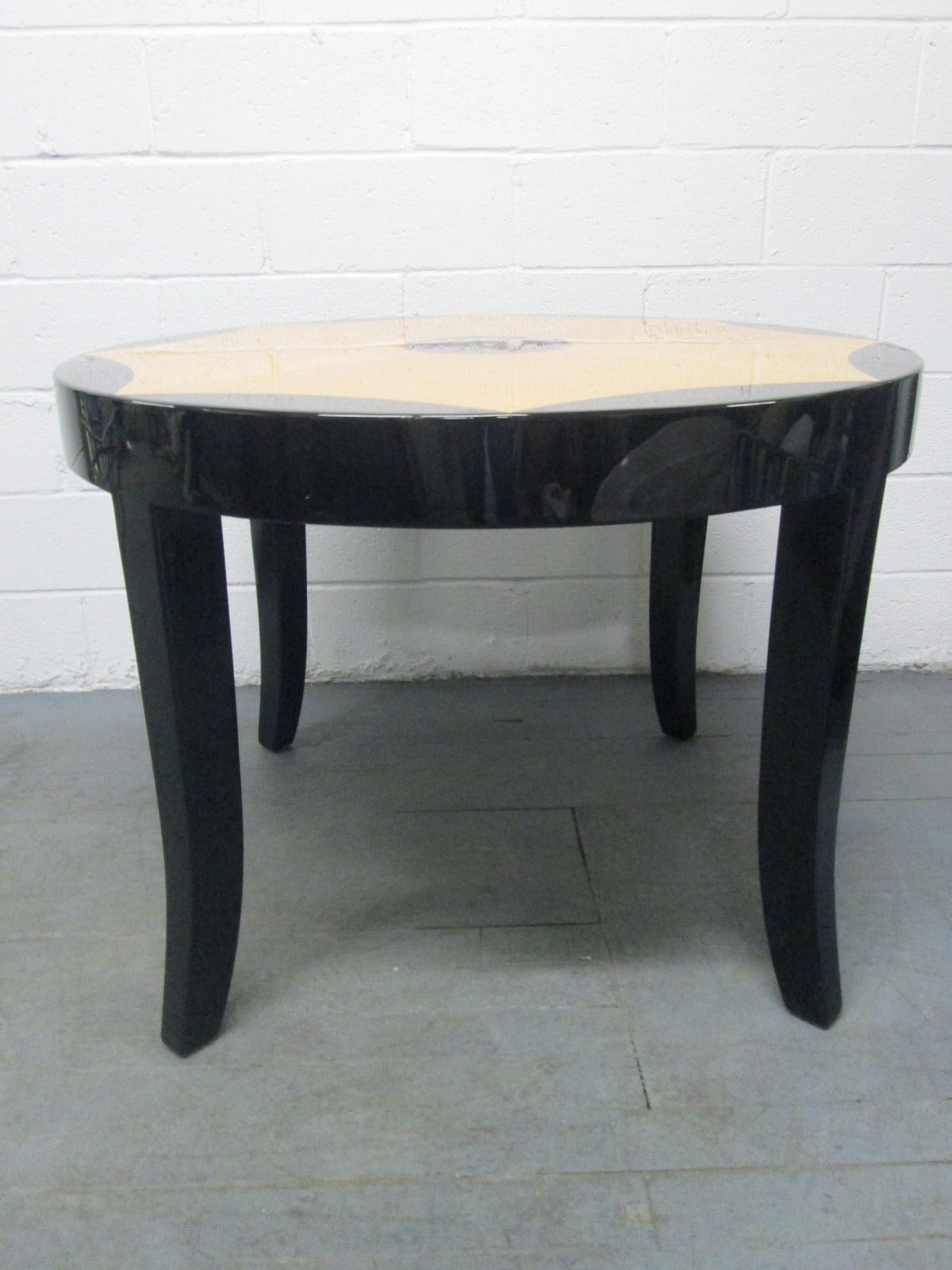 Black lacquered table with a high gloss finish with curly maple inlay. Can be used as a dining or center table.
