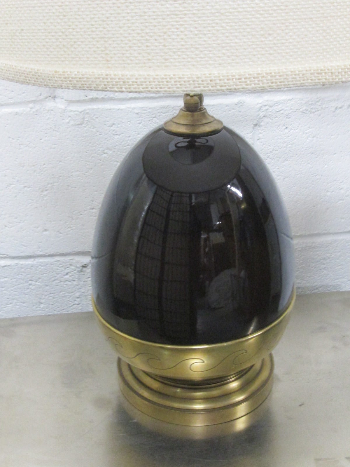 Brown ceramic and brass lamp. Has a decorative pattern to the brass.