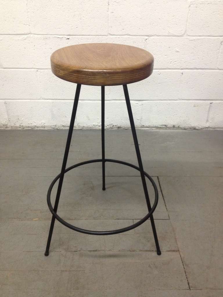 Pair of stools with a wrought iron base and wood seat. Seats do not swivel.
Measures: 30 H, seat diameter is 12.