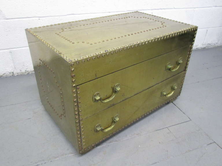 Brass clad chest of drawerswith two pull out drawers with brass rivets.