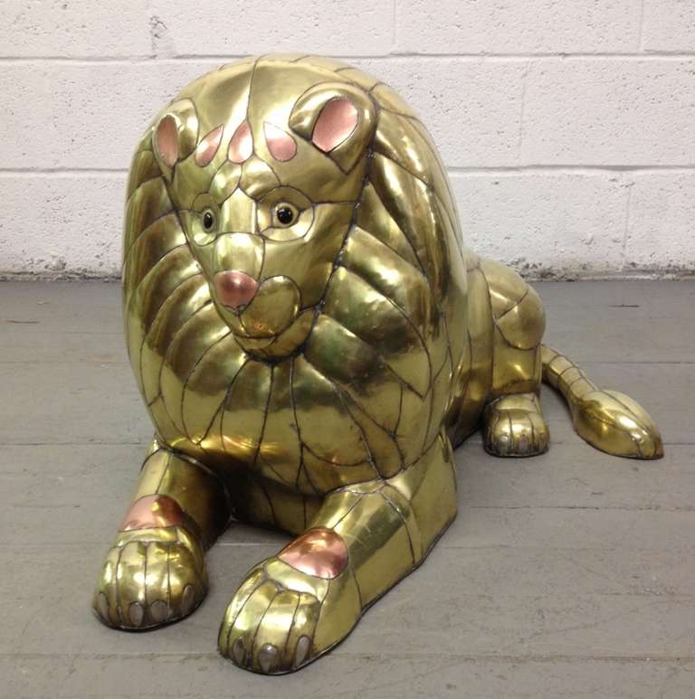 Lion sculpture in patchwork brass and copper by acclaimed Mexican artist and sculptor, Sergio Bustamante. This was done in the late 1970s. Tons of handcrafted detail which defines this piece. This is an unsigned example.