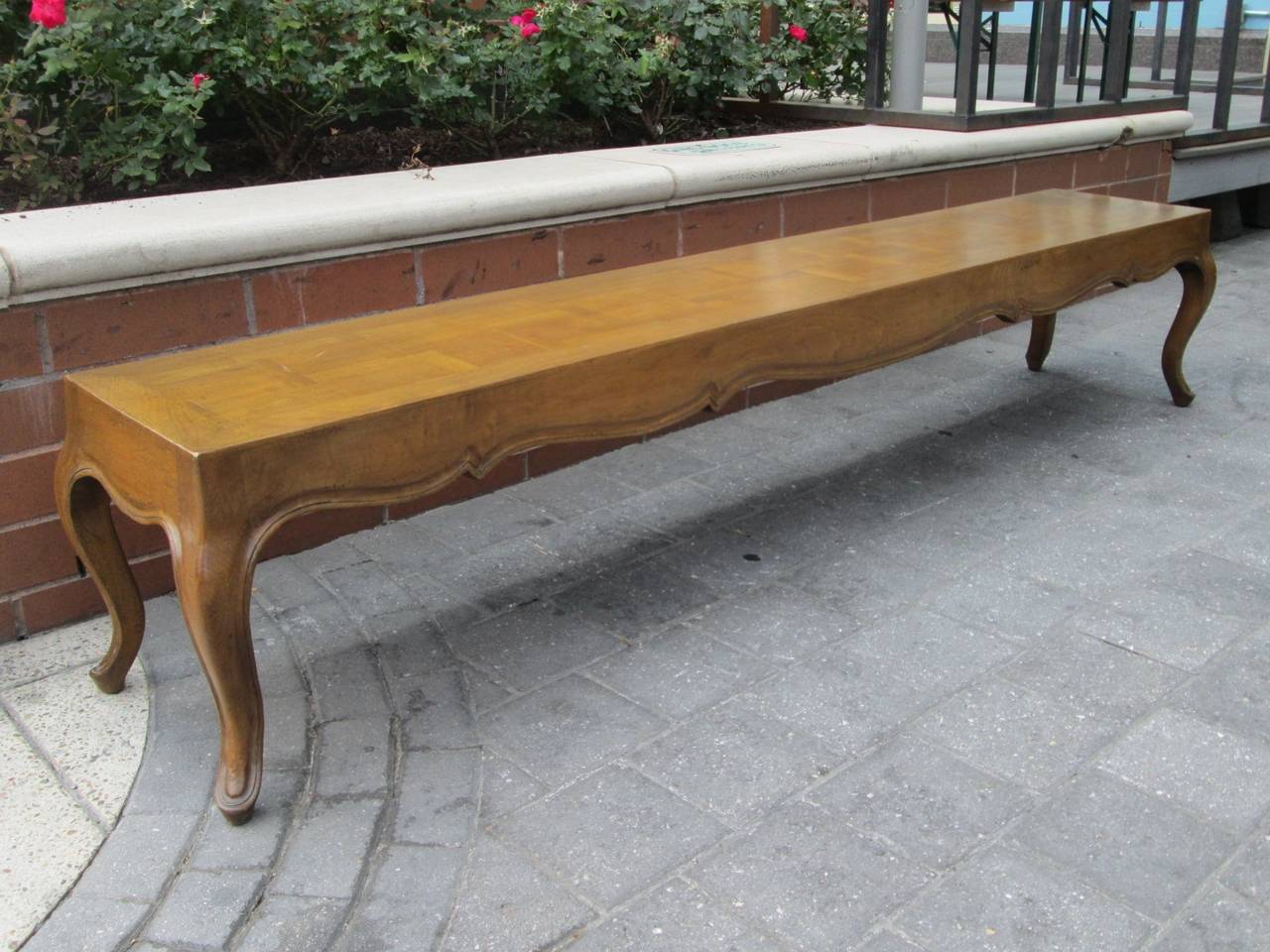 Long, French parquetry top bench. Bench is walnut. Has cabriole legs.  