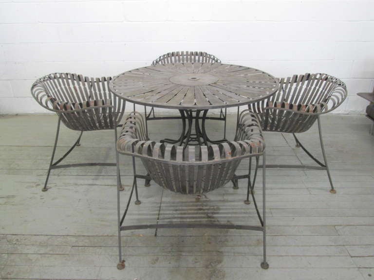 Fabulous table and chair set by Woodard. Set is steel and in its original condition. Great look for outdoors.

Table measures: 48