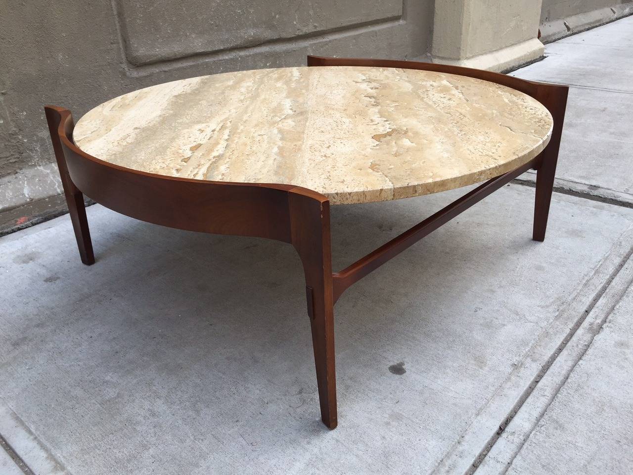 Coffee table with travertine top and a sculpted walnut frame, by Gordon Furniture Co.   Bertha Schaefer style. 