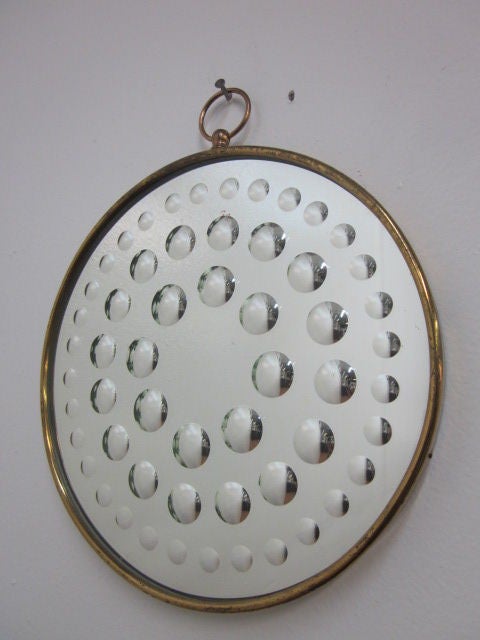 Italian, Piero Fornasetti optical mirror with round brass frame.