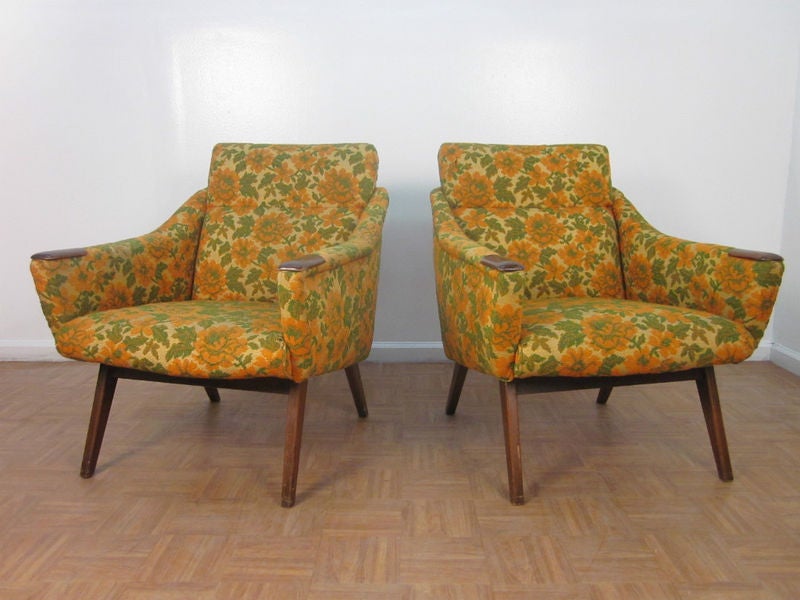 Wonderful pair of upholstered chairs with walnut arm tips and frame.  Has floral fabric pattern.