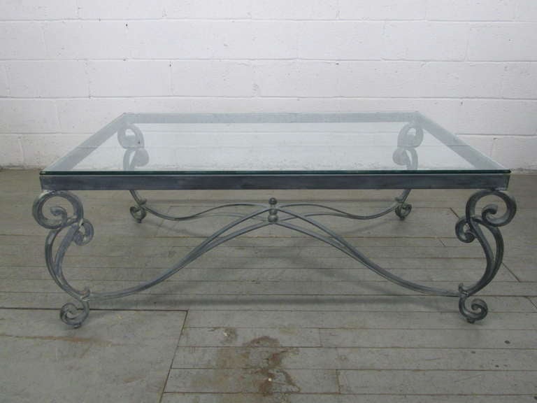 Glass top has beveled edge. Base has remains in the crevices of legs from being stripped which adds more character to the table. Some scratches to the glass. Table can be used in or outdoors.