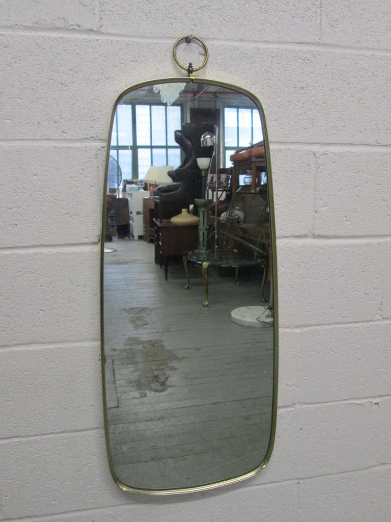 Italian brass mirror with a decorative ring at the top.
Measures: 39.5