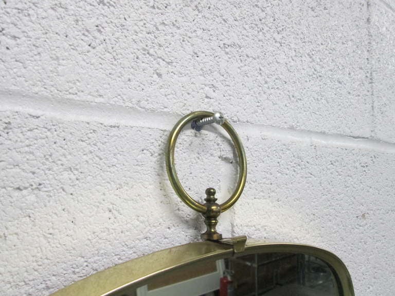 Mid-20th Century Italian Modernist Brass Mirror with a Decorative Ring at the Top