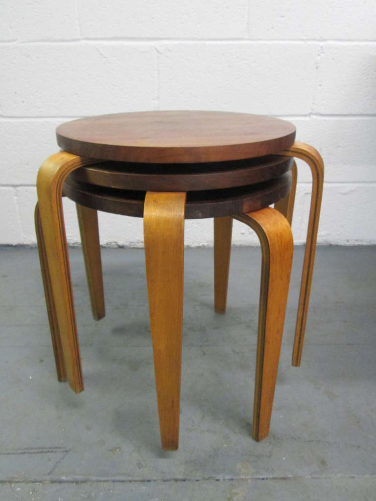 Stacking Bentwood Stools style of Alvar Aalto.  The stools have 3 L-legs of bent wood and a walnut seat.  Can be used as snack tables or end tables.  
Measures:  21