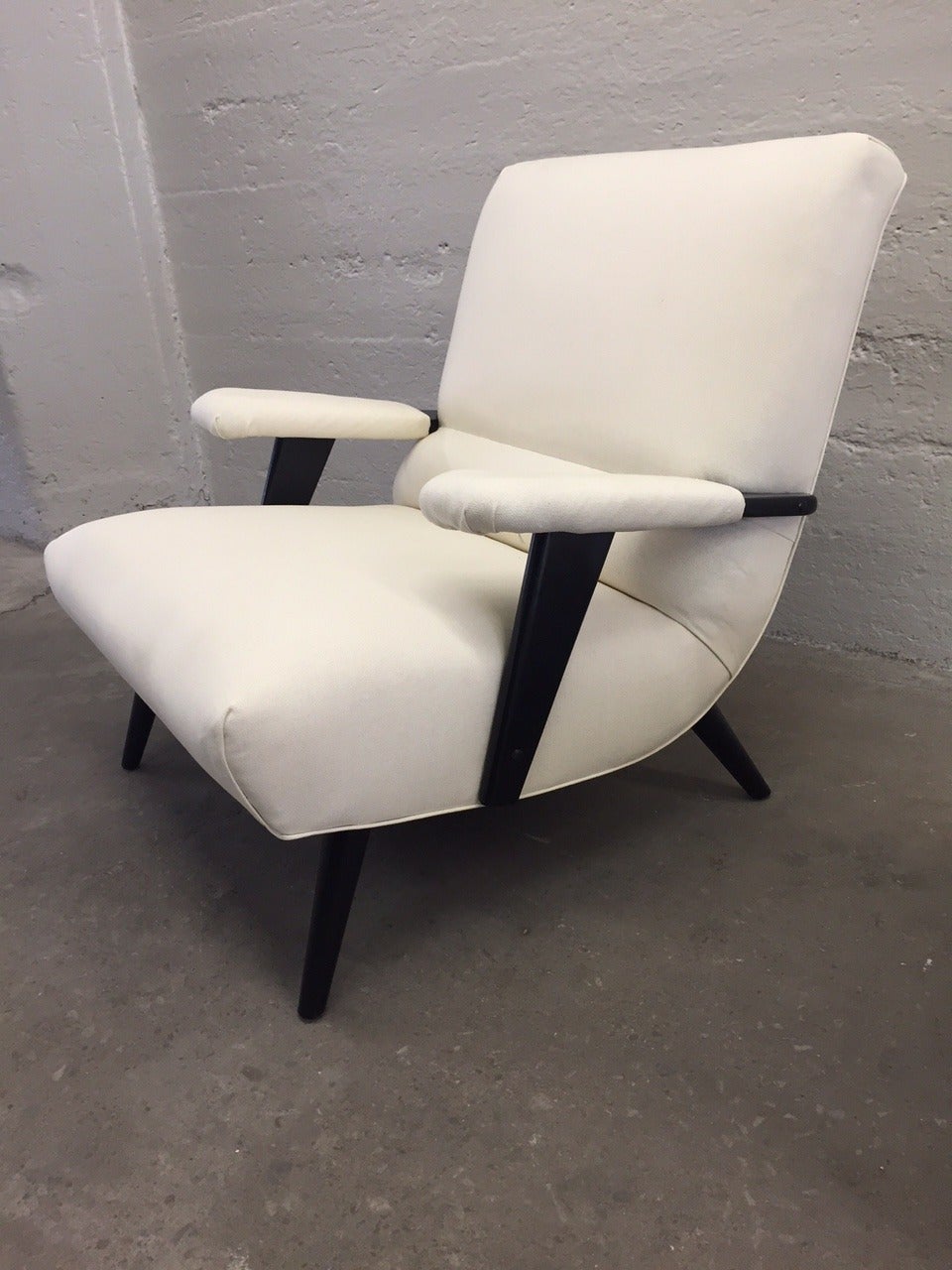 Italian lounge chair and matching ottoman. Black lacquered frame with newly upholstered linen blend fabric.