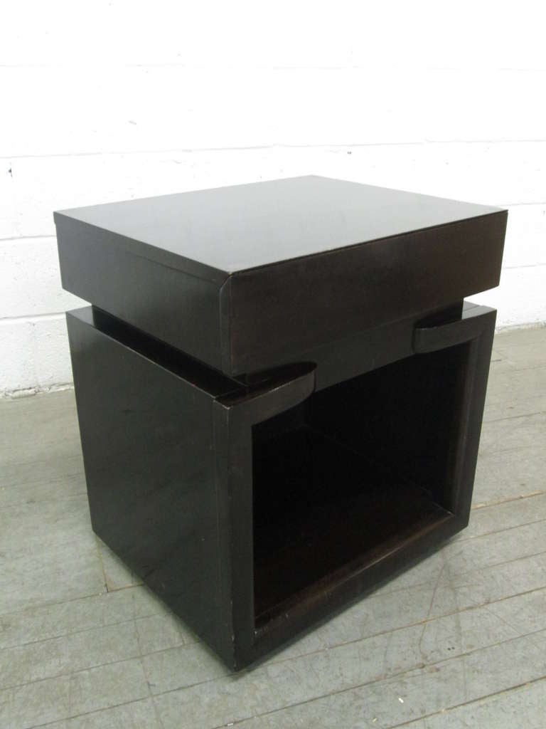 Pair of well designed nightstands attributed to James Mont.  Nightstands are mahogany with a single pull out drawer and an open space for storage.  Has  wheels for easy moving. Recommend refinishing.