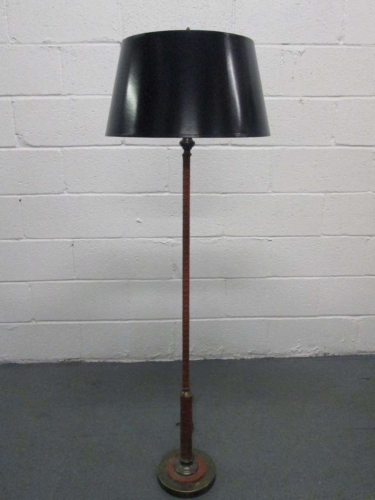 Jacques Adnet leather wrapped floor lamp in brown leather with brass trim.
Measures: 53