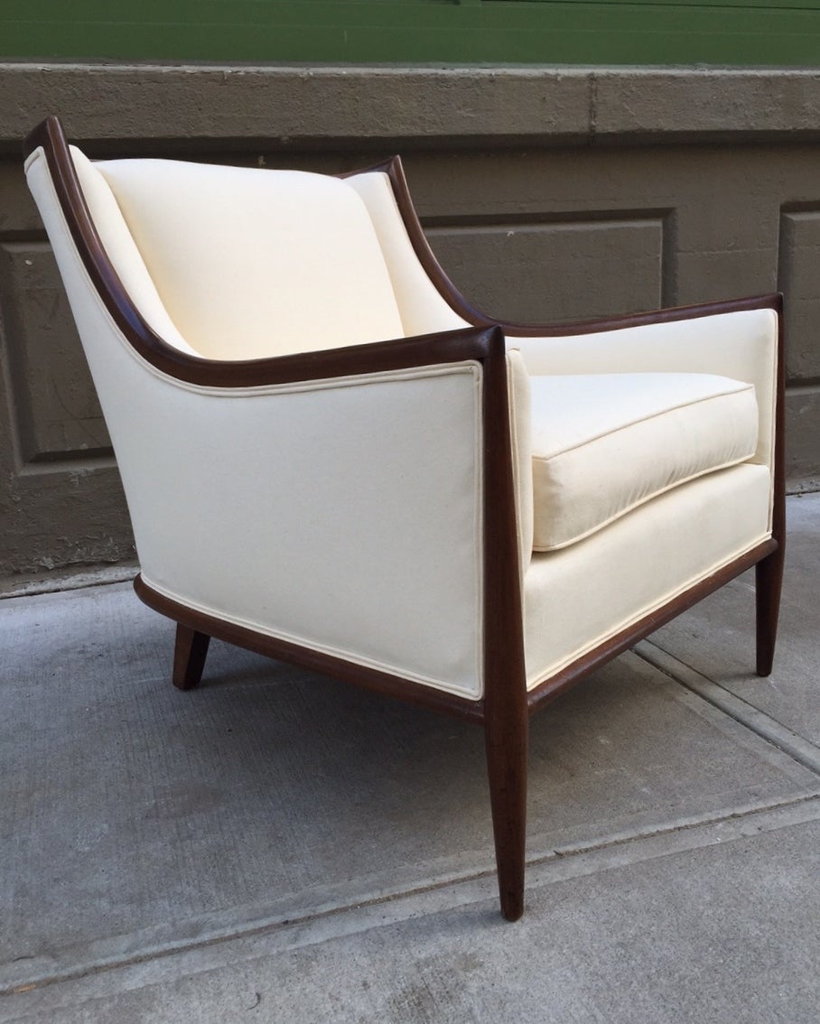 Pair of solid walnut and linen upholstered lounge chairs.
Chairs are style of Harvey Probber and/or style of Robsjohn-Gibbings.  