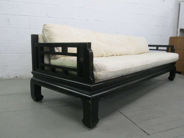 Designer sofa in the style of Michael Taylor for Baker Furniture Company.  The sofa has a black lacquered Asian style frame with loose cushioned seat and back.   Perfect for floating in a room as all sides are gorgeous.
Will need to be
