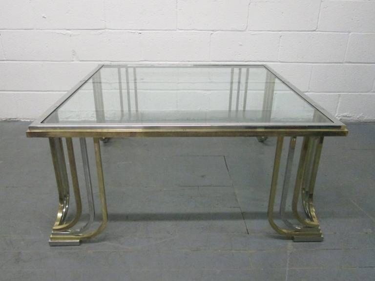 Brass and Chrome Coffee Table style of Karl Springer.
Legs has decorative curved legs.