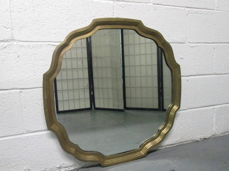 Solid brass scalloped edge mirror.