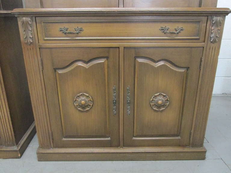Wonderful pair of Hollywood Regency cabinets with a sunburst etched glass doors. The middle of the sunburst is mercury. Cabinets have adjustable shelves to the top and bottom. The top inside of the cabinets are painted, have three glass shelves, and